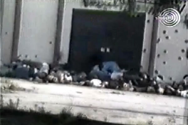 The footage made in front of the Kravica wearhouse shows about twenty bodies piled up 