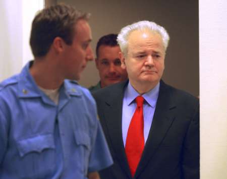 Slobodan Milosevic enters the courtroom